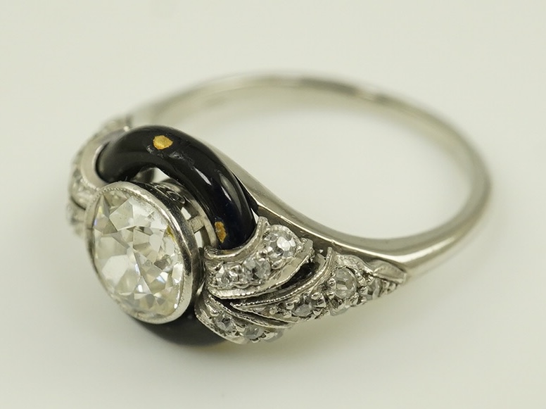 An Art Deco platinum black enamel and diamond set ring